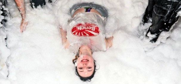 a girl lying on her back in foam